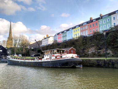 Colourful houses in Bristol across from the harbour